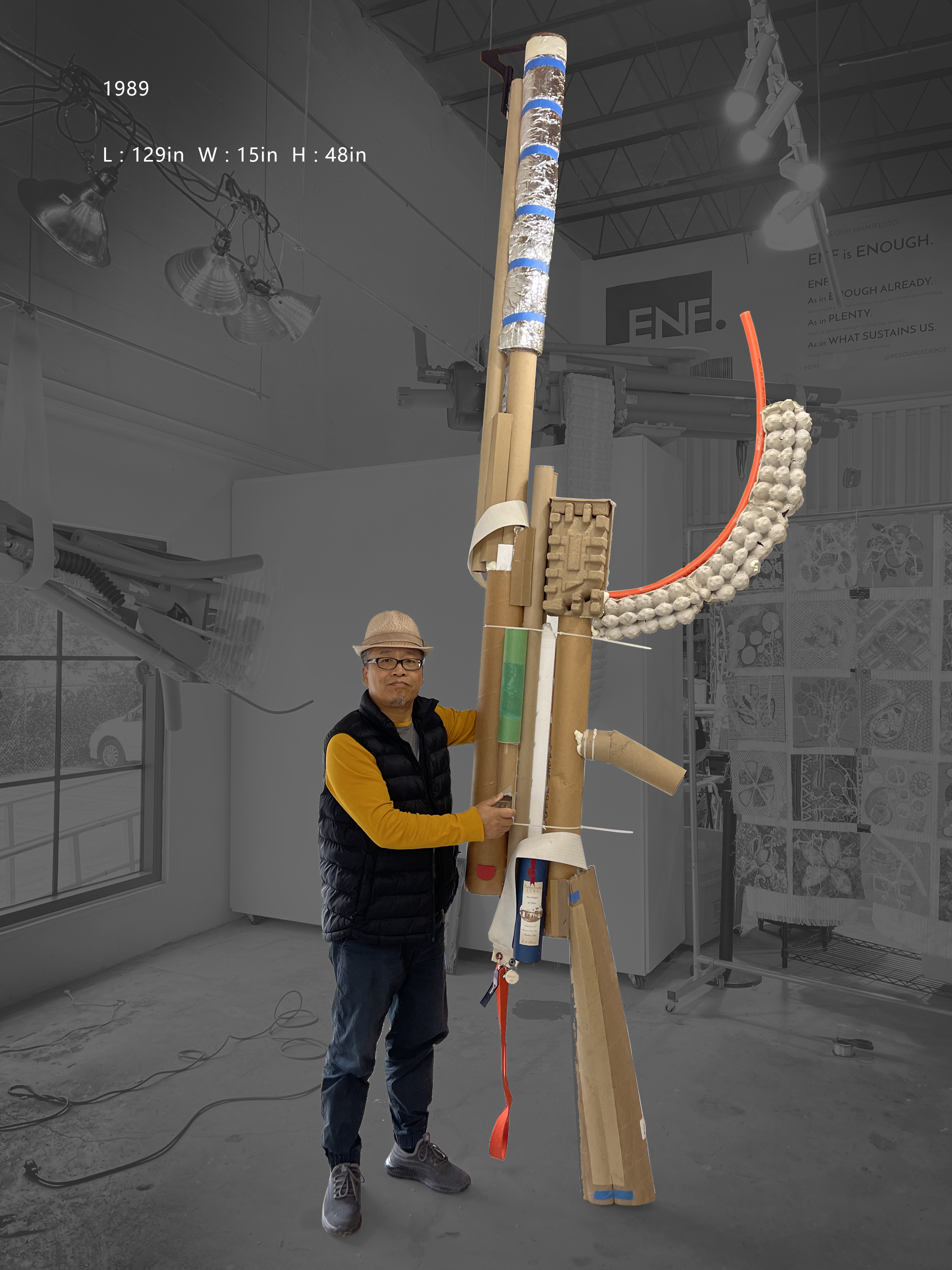 Zhongguo Zheng standing with 1989, a towering assemblage made from reclaimed cardboard, paper and other materials